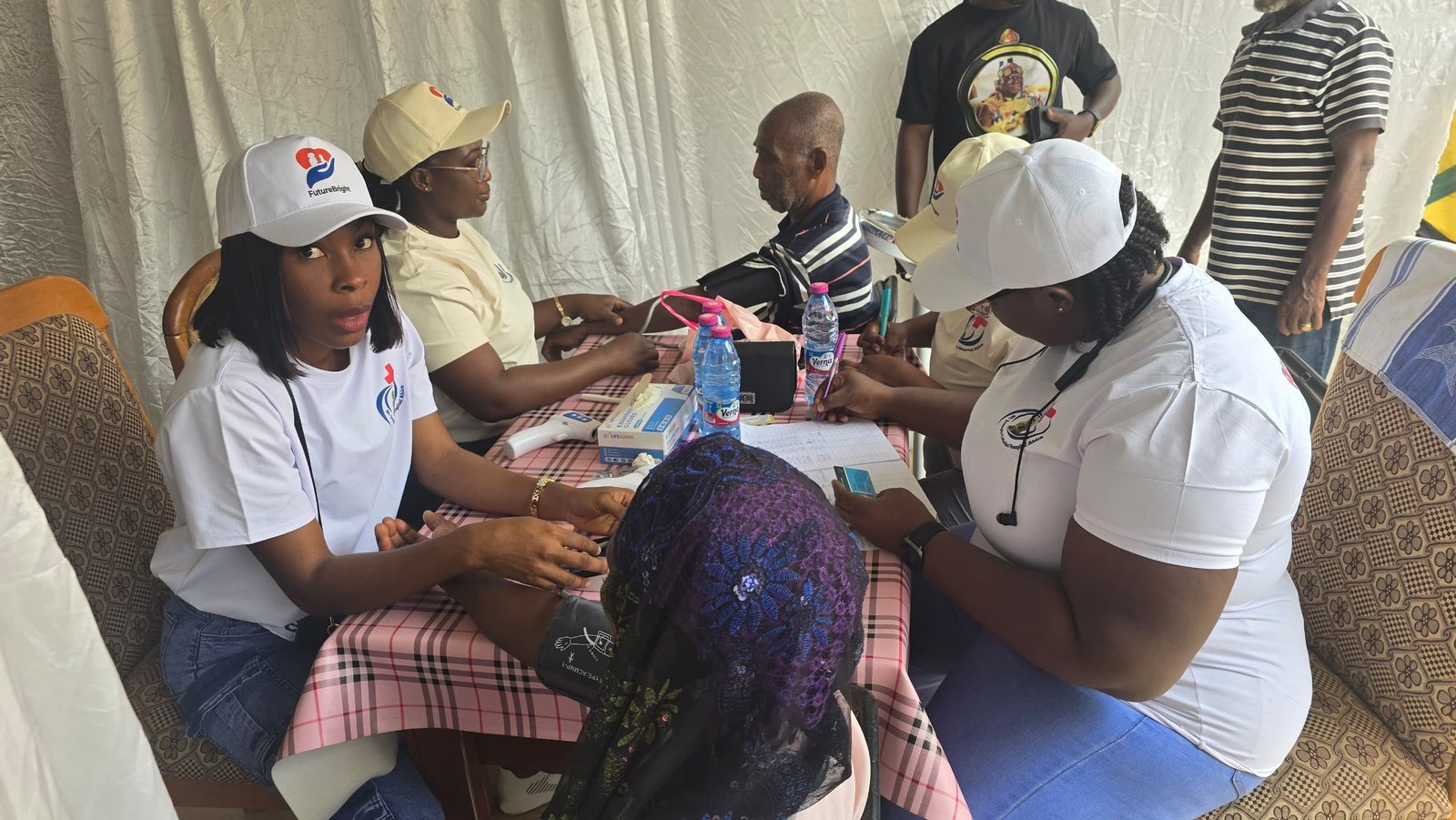 Volunteer clinicians screening patients in Abira, Ghana